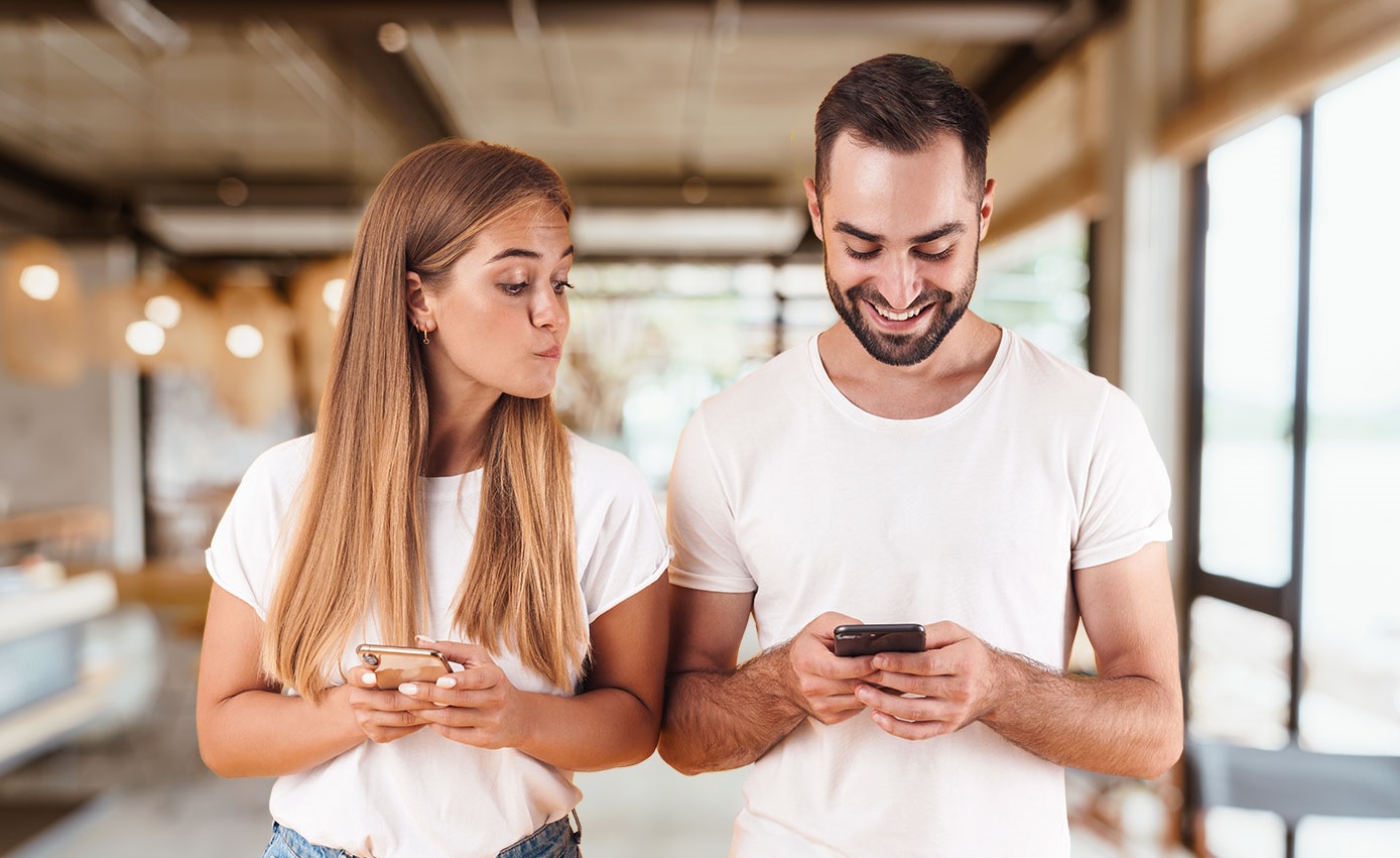 Curious Friend Peeking at Smartphone